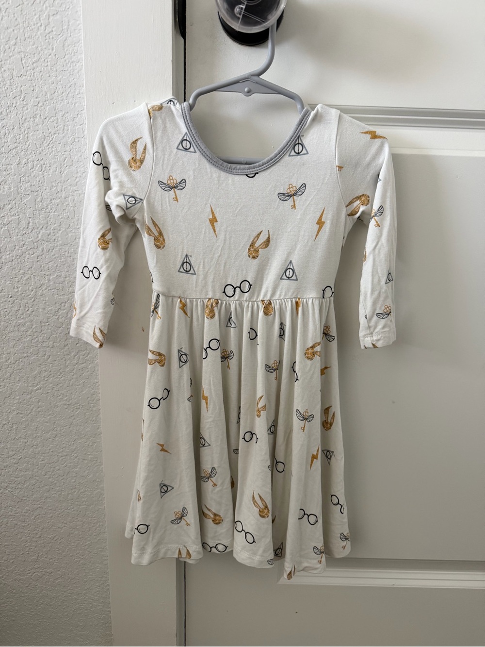 Kyte BABY Cream Dress with Gold & Black Magic Prints